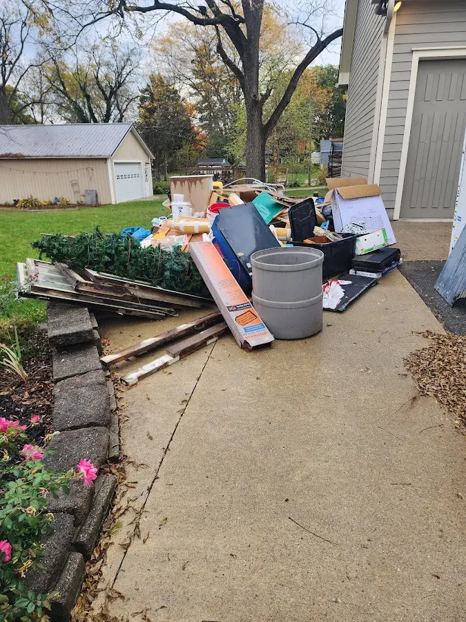 Dumpster being loaded with debris for 10 Yard Dumpster Rental in Revere